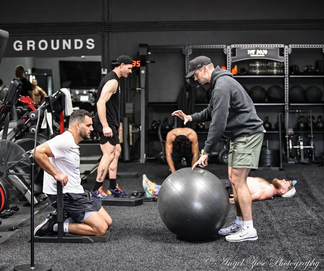Dr. Tyler Slamans coaching athletes through the training portion at The Village ATG